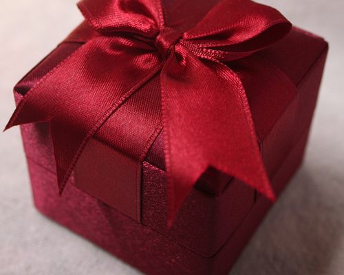 Red gift box with red ribbon