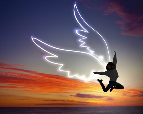 Young girl with drawn wings jumping high in sky