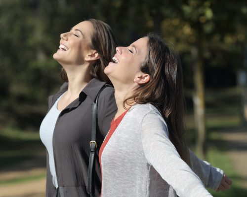 Two happy friends breathing fresh air together